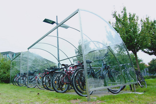 Fahrräder stehen unter einem überdachten Fahrradständer