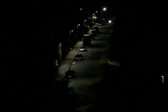 Blick auf eine beleuchtete Straße im dunkeln