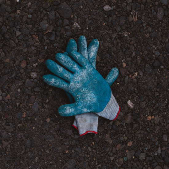 Zwei blaue Handschuhe liegen auf dem Boden
