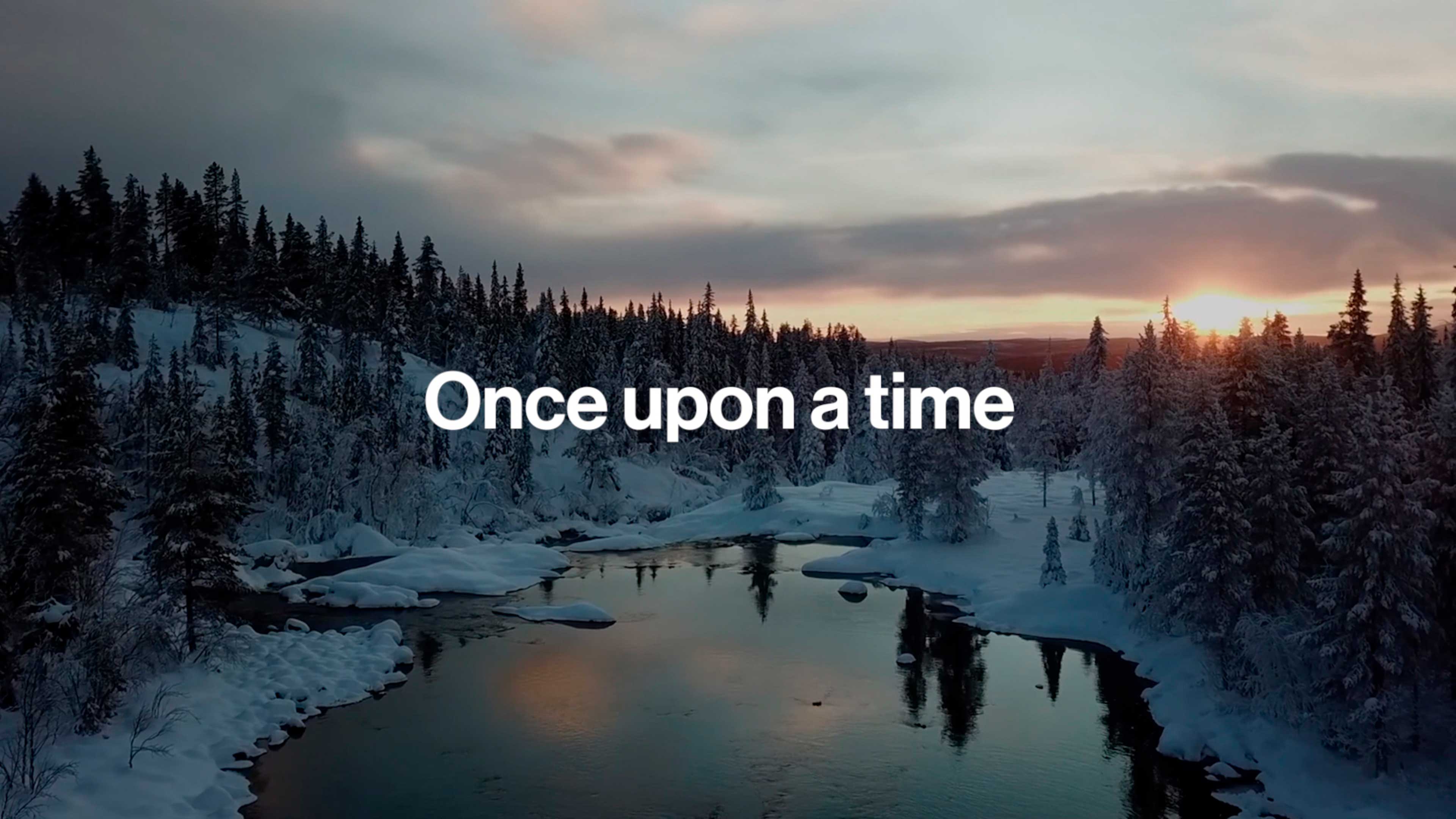 Bild einer Schneelandschaft bei Sonnenuntergang, Text „Once upon a time“.